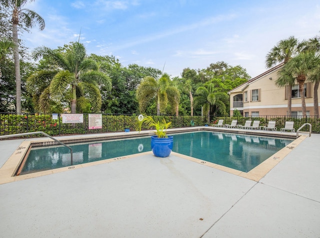 815 W Boynton Beach Blvd Unit 15-203, Boynton Beach, FL 33426 - community pool featuring a patio and view of wooded area