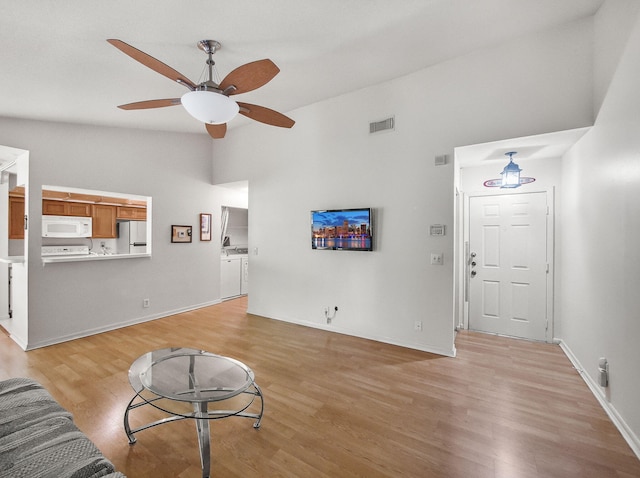 815 W Boynton Beach Blvd Unit 15-203, Boynton Beach, FL 33426 - living area with light wood finished floors, ceiling fan, vaulted ceiling, and baseboards