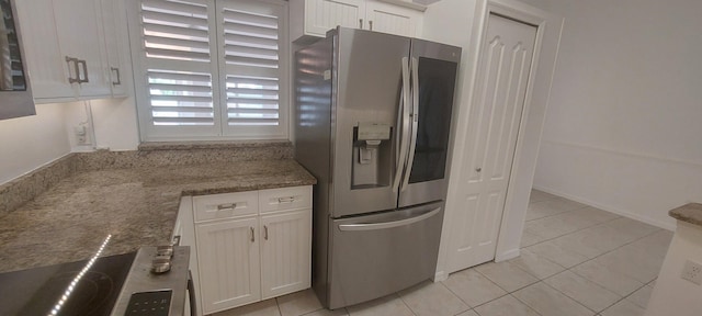 456 NW Marsala Ter, Port Saint Lucie, FL 34986 - kitchen with stainless steel refrigerator with ice dispenser, light tile patterned floors, white cabinets, and stove