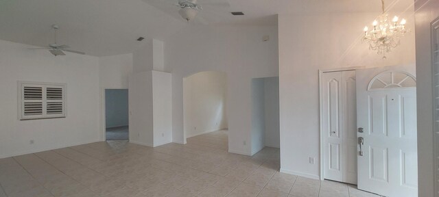 456 NW Marsala Ter, Port Saint Lucie, FL 34986 - empty room featuring ceiling fan, high vaulted ceiling, arched walkways, a chandelier, and light tile patterned floors