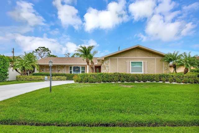 519 SE Brookside Ter, Port Saint Lucie, FL 34983 - single story home featuring a front lawn, stucco siding, stone siding, and driveway