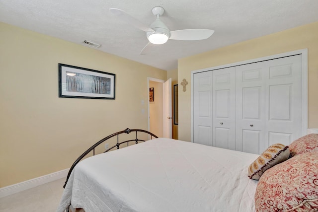 519 SE Brookside Ter, Port Saint Lucie, FL 34983 - bedroom with a closet, baseboards, ceiling fan, and a textured ceiling