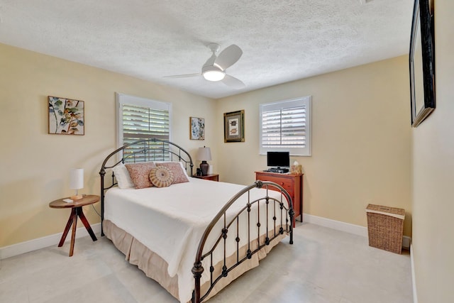 519 SE Brookside Ter, Port Saint Lucie, FL 34983 - bedroom with multiple windows, ceiling fan, baseboards, and a textured ceiling
