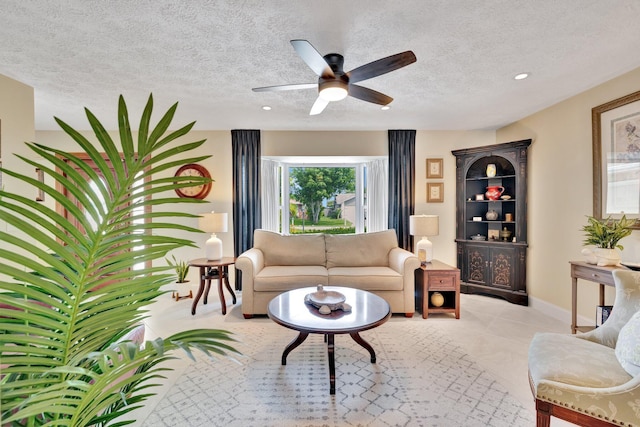 519 SE Brookside Ter, Port Saint Lucie, FL 34983 - living area with a textured ceiling, ceiling fan, recessed lighting, and baseboards