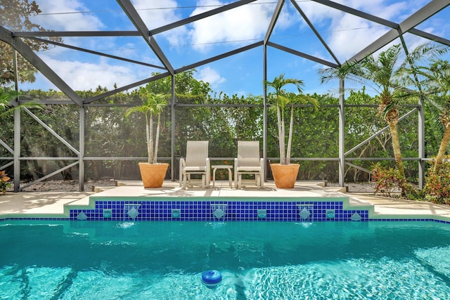 519 SE Brookside Ter, Port Saint Lucie, FL 34983 - swimming pool with glass enclosure and a patio area