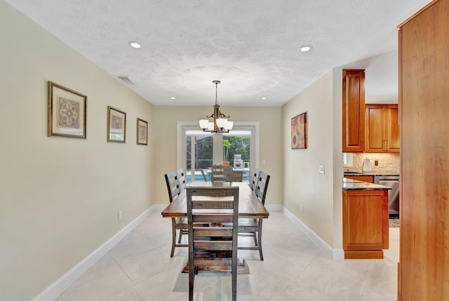 519 SE Brookside Ter, Port Saint Lucie, FL 34983 - dining space with a chandelier, a textured ceiling, light tile patterned flooring, baseboards, and recessed lighting