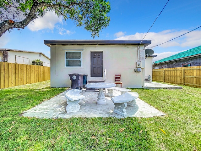 903 21st St, West Palm Beach, FL 33407 - back of property with stucco siding and a patio