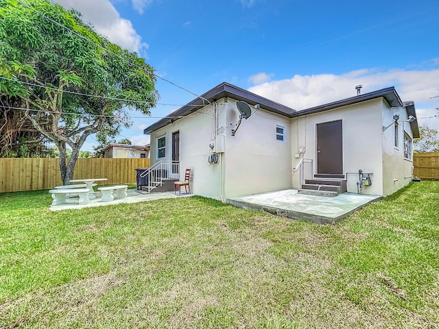903 21st St, West Palm Beach, FL 33407 - rear view of house with entry steps, a patio area, and stucco siding