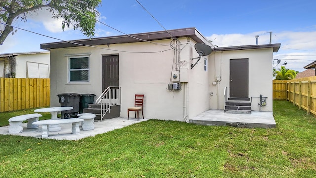 903 21st St, West Palm Beach, FL 33407 - back of house featuring stucco siding and entry steps