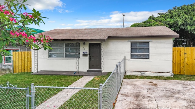 903 21st St, West Palm Beach, FL 33407 - view of front of property with a gate, brick siding, and a shingled roof