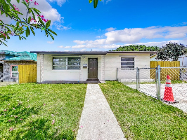 903 21st St, West Palm Beach, FL 33407 - ranch-style house featuring a gate and brick siding