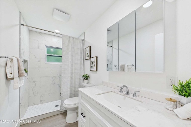 2318 Old Samsula Rd, Port Orange, FL 32128 - full bathroom featuring toilet, vanity, tiled shower, and wood finished floors