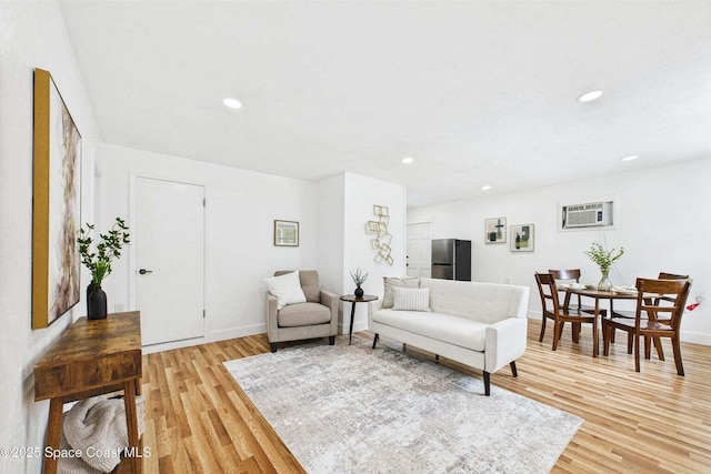 2318 Old Samsula Rd, Port Orange, FL 32128 - living room with light wood finished floors, recessed lighting, baseboards, and a wall mounted air conditioner