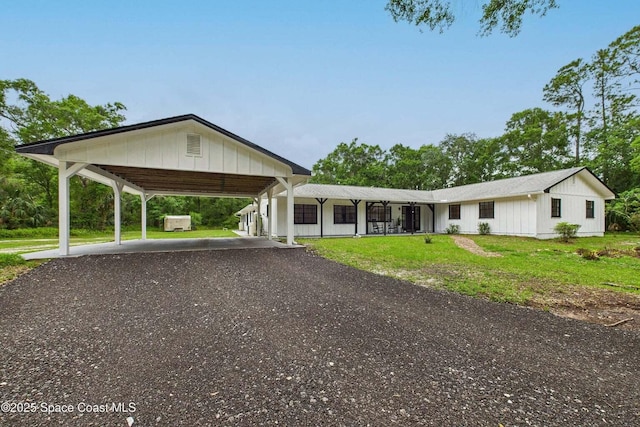 2318 Old Samsula Rd, Port Orange, FL 32128 - view of front of property featuring a front lawn, gravel driveway, and a carport