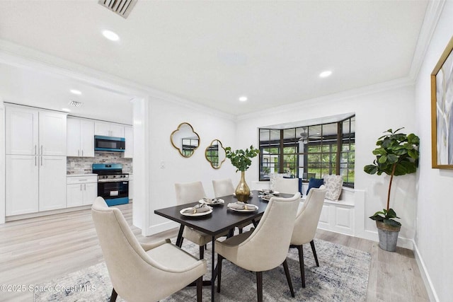 2318 Old Samsula Rd, Port Orange, FL 32128 - dining space featuring light wood-type flooring, crown molding, recessed lighting, and baseboards