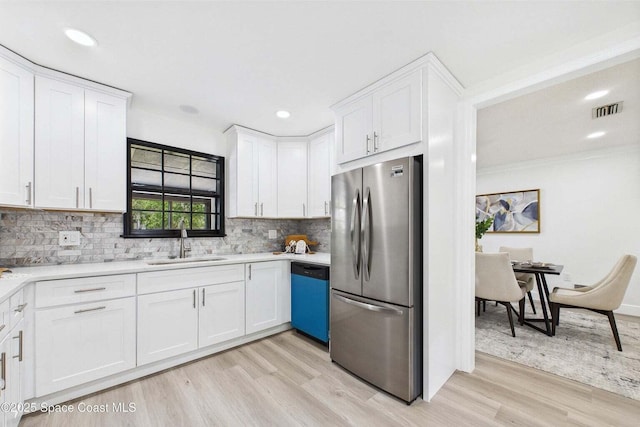 2318 Old Samsula Rd, Port Orange, FL 32128 - kitchen featuring freestanding refrigerator, dishwasher, a sink, white cabinets, and light wood-style floors