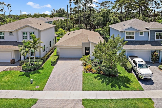 6825 Pointe Of Woods Dr, West Palm Beach, FL 33413 - traditional home with decorative driveway, stucco siding, a front yard, and a garage