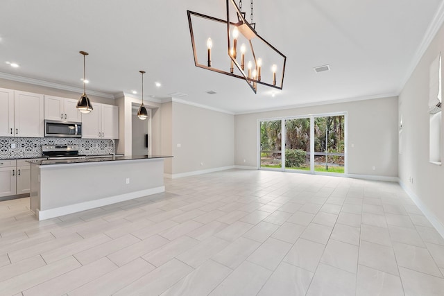 6825 Pointe Of Woods Dr, West Palm Beach, FL 33413 - kitchen featuring appliances with stainless steel finishes, open floor plan, decorative backsplash, crown molding, and dark countertops