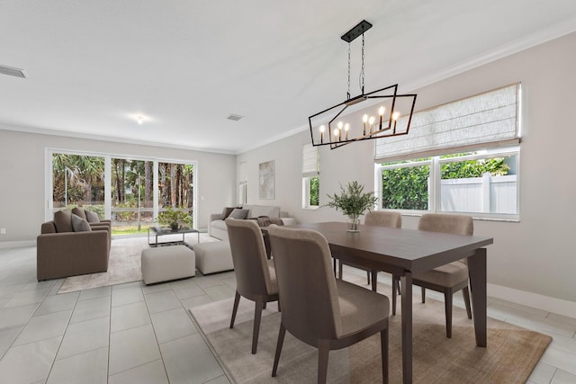 6825 Pointe Of Woods Dr, West Palm Beach, FL 33413 - dining area with a chandelier, crown molding, light tile patterned floors, and baseboards