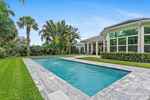 7737 Preserve Dr, West Palm Beach, FL 33412 - swimming pool featuring a patio and a lawn