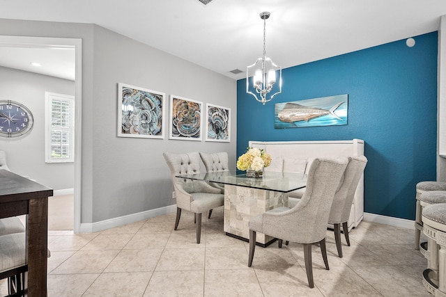 2381 SW Island Creek Trl, Palm City, FL 34990 - dining area with a chandelier, baseboards, and tile patterned flooring