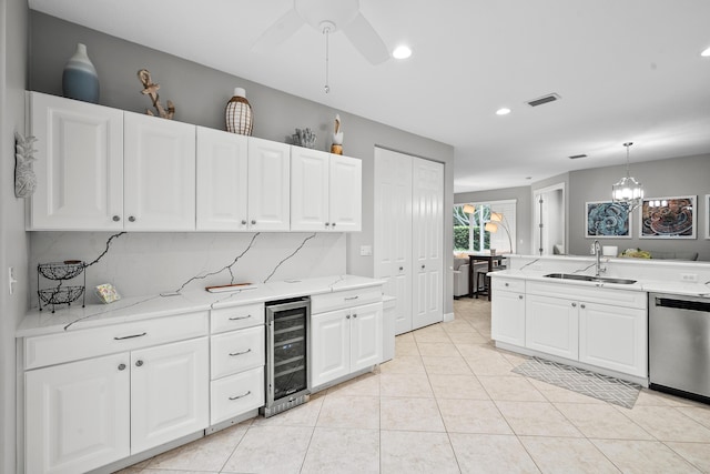 2381 SW Island Creek Trl, Palm City, FL 34990 - kitchen with wine cooler, a sink, stainless steel dishwasher, light tile patterned flooring, and white cabinets