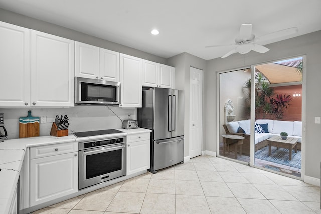 2381 SW Island Creek Trl, Palm City, FL 34990 - kitchen featuring appliances with stainless steel finishes, light countertops, baseboards, white cabinets, and recessed lighting