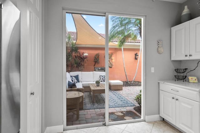 2381 SW Island Creek Trl, Palm City, FL 34990 - doorway with baseboards and light tile patterned flooring