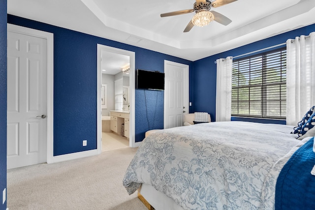 2381 SW Island Creek Trl, Palm City, FL 34990 - bedroom featuring a tray ceiling, carpet, baseboards, a textured wall, and a ceiling fan