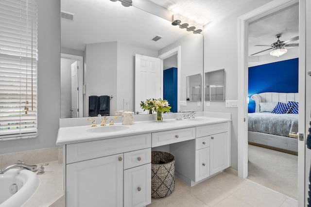 2381 SW Island Creek Trl, Palm City, FL 34990 - ensuite bathroom featuring double vanity, tile patterned flooring, a bath, and a ceiling fan