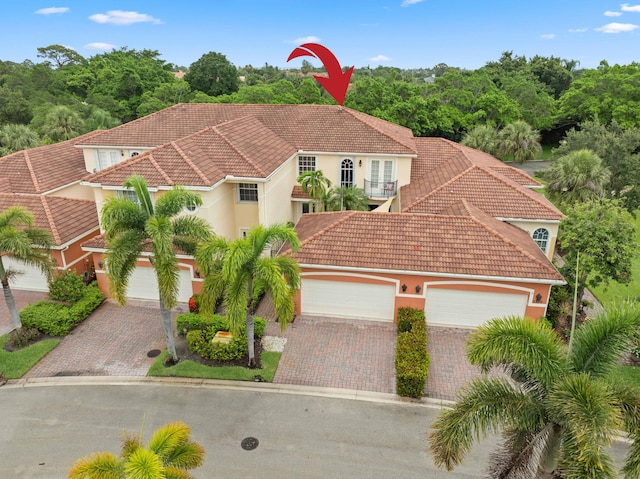 2381 SW Island Creek Trl, Palm City, FL 34990 - mediterranean / spanish home with a tiled roof and decorative driveway
