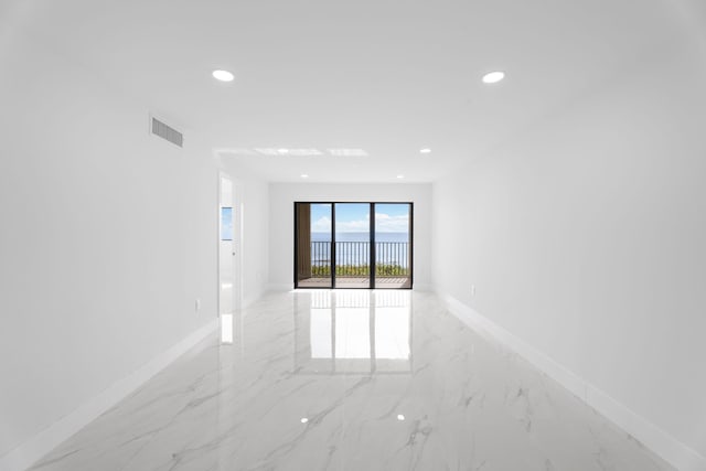 7420 S Ocean Dr Unit 314, Jensen Beach, FL 34957 - empty room with light marble finish flooring, recessed lighting, and baseboards