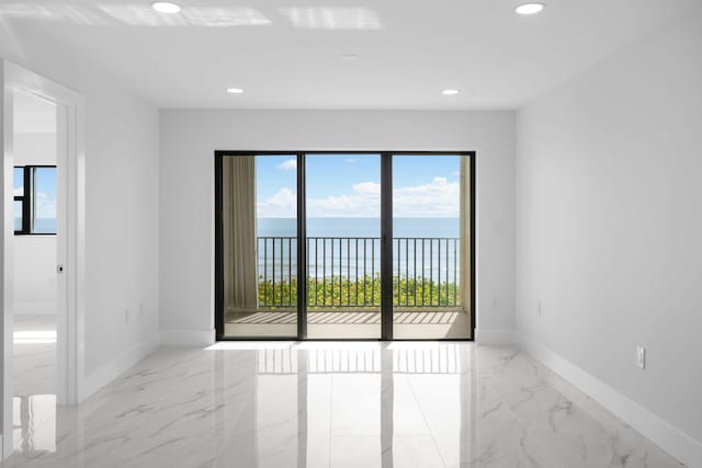 7420 S Ocean Dr Unit 314, Jensen Beach, FL 34957 - unfurnished room featuring light marble finish floors, baseboards, recessed lighting, and a water view