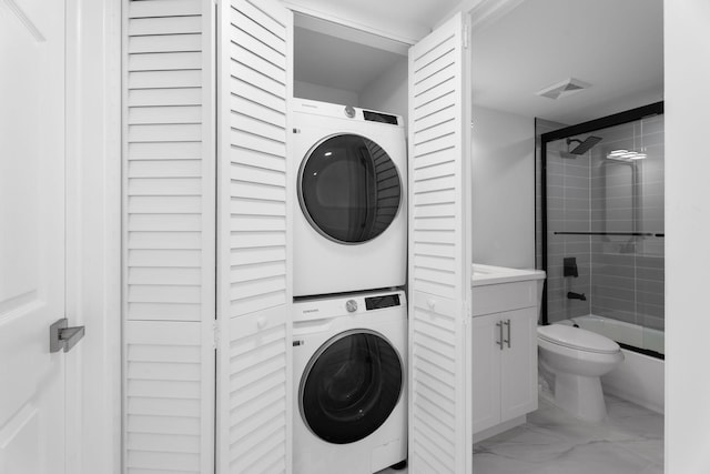 7420 S Ocean Dr Unit 314, Jensen Beach, FL 34957 - laundry room with stacked washing machine and dryer and light marble finish flooring