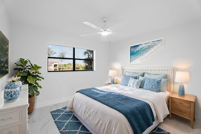 7420 S Ocean Dr Unit 314, Jensen Beach, FL 34957 - bedroom with light marble finish flooring, baseboards, and ceiling fan