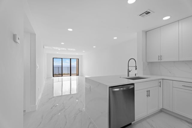 7420 S Ocean Dr Unit 314, Jensen Beach, FL 34957 - kitchen with stainless steel dishwasher, a sink, light marble finish floors, light stone counters, and recessed lighting