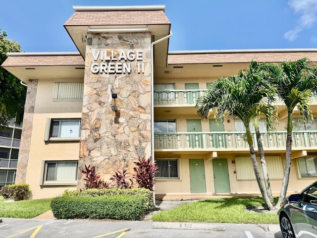 200 Village Green Cir E Unit 102, Palm Springs, FL 33461 - view of apartment building / complex with uncovered parking