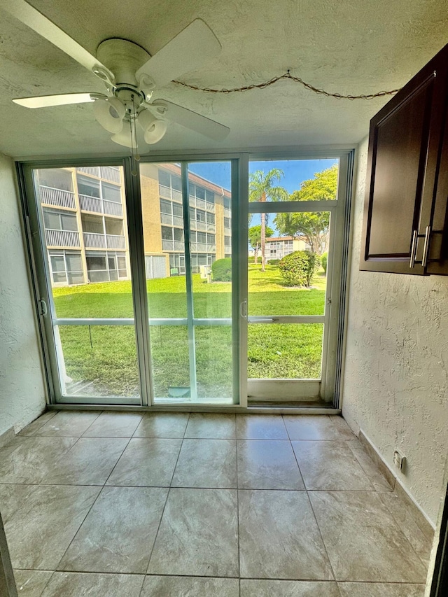 200 Village Green Cir E Unit 102, Palm Springs, FL 33461 - unfurnished sunroom featuring healthy amount of natural light and ceiling fan