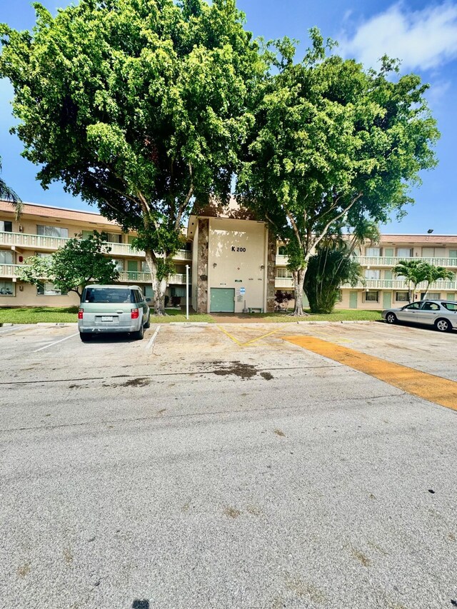 200 Village Green Cir E Unit 102, Palm Springs, FL 33461 - view of front facade featuring uncovered parking