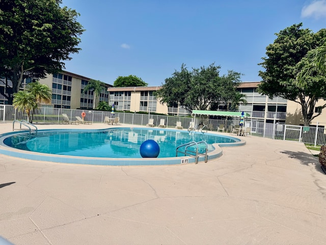 200 Village Green Cir E Unit 102, Palm Springs, FL 33461 - community pool with a patio area