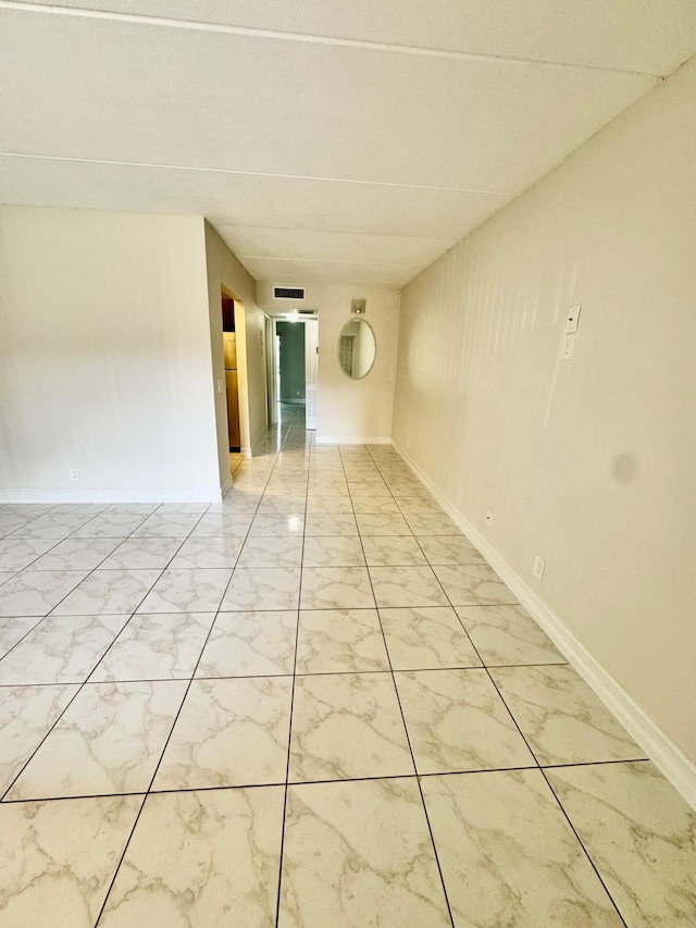 200 Village Green Cir E Unit 102, Palm Springs, FL 33461 - unfurnished room featuring light marble finish flooring and baseboards