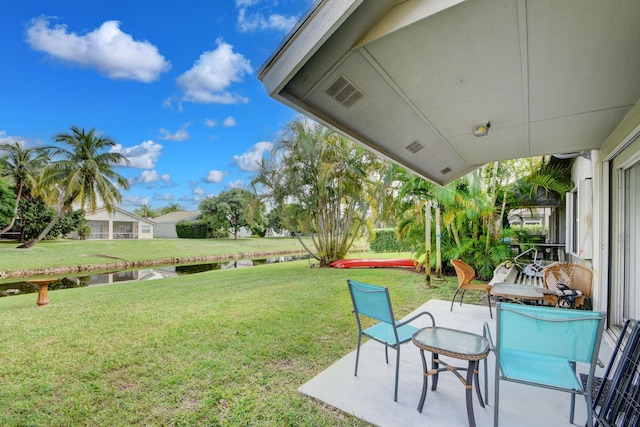 13134 Quiet Woods Rd Unit A, Wellington, FL 33414 - view of green lawn featuring a water view and a patio