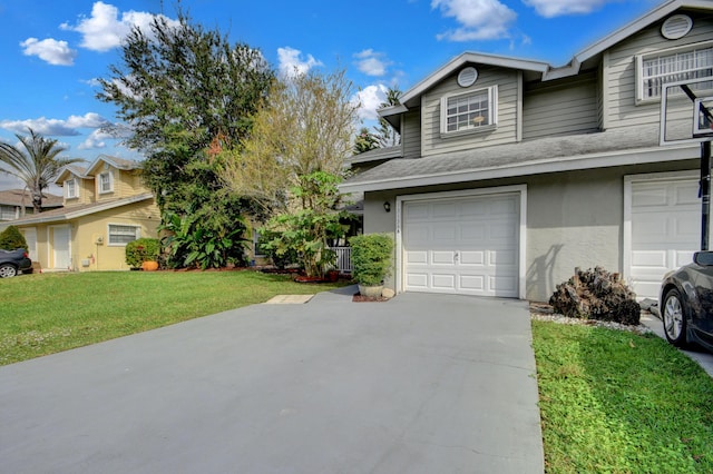 13134 Quiet Woods Rd Unit A, Wellington, FL 33414 - view of front of home featuring a front lawn, an attached garage, concrete driveway, stucco siding, and roof with shingles