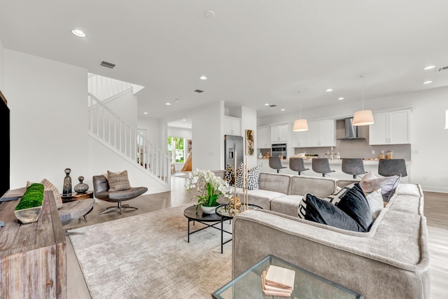 13330 Machiavelli Way, Palm Beach Gardens, FL 33418 - living room with light wood finished floors, recessed lighting, stairs, and baseboards