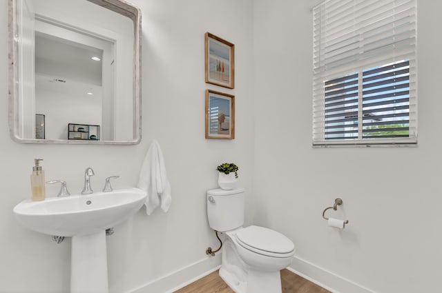 13330 Machiavelli Way, Palm Beach Gardens, FL 33418 - half bathroom featuring baseboards, wood finished floors, and toilet