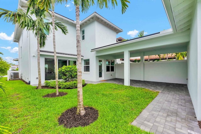 13330 Machiavelli Way, Palm Beach Gardens, FL 33418 - rear view of house with a lawn and stucco siding