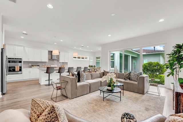 13330 Machiavelli Way, Palm Beach Gardens, FL 33418 - living room with light wood-type flooring and recessed lighting