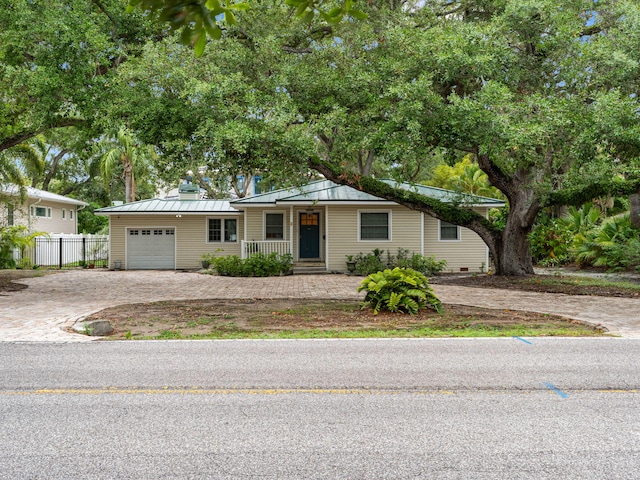 6201 Bayshore Blvd, Tampa, FL 33611 - view of front facade featuring decorative driveway, a standing seam roof, covered porch, metal roof, and a garage