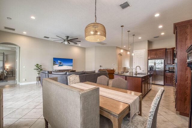 10295 SW Waterway Ln, Port Saint Lucie, FL 34987 - dining space featuring arched walkways, ceiling fan, light tile patterned flooring, and recessed lighting