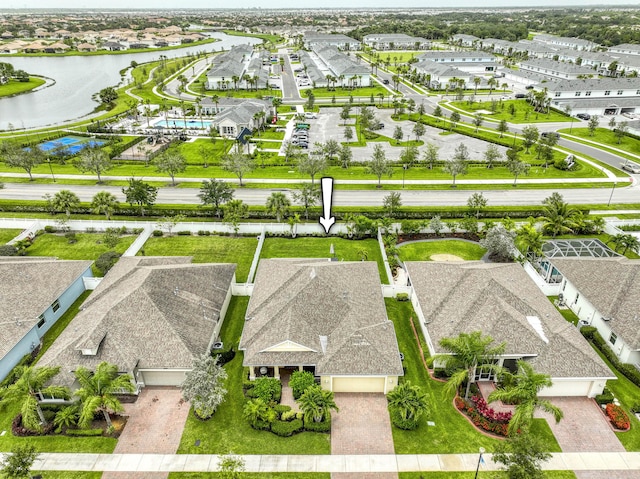 10295 SW Waterway Ln, Port Saint Lucie, FL 34987 - view of front facade with decorative driveway, a garage, a front lawn, stucco siding, and roof with shingles